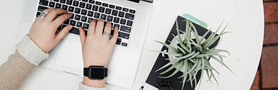 Person Typing on Laptop Keyboard